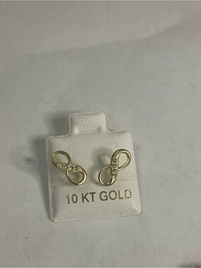 10K yellow gold infinity stud earrings feature small CZ stones in a polished